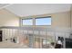 Upper-level view showcases staircase, windows, and a cozy sitting area below at 7160 W Stetson Pl # 27, Littleton, CO 80123