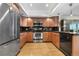 Contemporary kitchen with stainless steel appliances and sleek black backsplash at 7160 W Stetson Pl # 27, Littleton, CO 80123