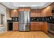 Well-lit kitchen with modern stainless steel refrigerator and updated wooden cabinets at 7160 W Stetson Pl # 27, Littleton, CO 80123