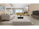 Bright living room with fireplace, plush seating, and sliding doors to outdoor view at 7160 W Stetson Pl # 27, Littleton, CO 80123