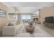 Bright living room featuring a fireplace, access to a balcony, and neutral-toned furniture with a decorative rug at 7160 W Stetson Pl # 27, Littleton, CO 80123