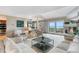 Bright living room featuring plush seating, fireplace, and sliding glass doors with lake views at 7160 W Stetson Pl # 27, Littleton, CO 80123