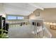 Carpeted loft area with white railing, vaulted ceilings, and lots of natural light through large windows at 7160 W Stetson Pl # 27, Littleton, CO 80123