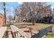 Large backyard with multiple seating areas and mature trees providing ample shade at 1581 N Ogden St, Denver, CO 80218