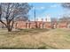 Expansive backyard featuring a brick building with multiple doors and a spacious grassy area at 1581 N Ogden St, Denver, CO 80218