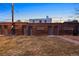 Spacious backyard featuring a brick building with multiple doors and a grassy lawn at 1581 N Ogden St, Denver, CO 80218