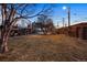 Beautiful backyard with stairs to deck, and picnic tables surrounded by mature trees at 1581 N Ogden St, Denver, CO 80218