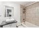 Stylish bathroom with a modern sink, neutral tile, and a shower-tub combination at 1581 N Ogden St, Denver, CO 80218