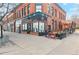 Corner building with a stylish wine bar featuring outdoor seating and classic brick architecture at 1581 N Ogden St, Denver, CO 80218