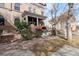 Brick house with covered porch, red awning, and garden area in front at 1581 N Ogden St, Denver, CO 80218