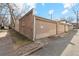 The garage has a neutral color garage door with brick siding at 1581 N Ogden St, Denver, CO 80218