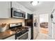 Kitchen features stainless steel appliances and access to the living room at 1581 N Ogden St, Denver, CO 80218