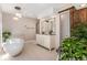 Bright bathroom with free standing tub, double sink vanity, and unique sliding door at 34498 Forest Estates Rd, Evergreen, CO 80439