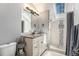 Elegant bathroom featuring a shower with a skylight, granite counters, and modern fixtures at 34498 Forest Estates Rd, Evergreen, CO 80439