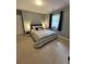 Cozy bedroom features neutral colors, a plush striped comforter and a window letting in natural light at 34498 Forest Estates Rd, Evergreen, CO 80439