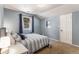 Comfortable bedroom with blue accent wall, soft carpet, and a window view at 34498 Forest Estates Rd, Evergreen, CO 80439