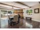 Charming dining room with exposed brick fireplace and access to outdoor deck at 34498 Forest Estates Rd, Evergreen, CO 80439