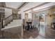 Elegant dining area with exposed beams, a cozy fireplace, and hardwood floors at 34498 Forest Estates Rd, Evergreen, CO 80439