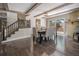 Open dining room with wood beams, fireplace, and walkout to deck with a view at 34498 Forest Estates Rd, Evergreen, CO 80439