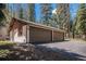 Spacious three-car garage with an ample driveway, offering plenty of parking and storage space at 34498 Forest Estates Rd, Evergreen, CO 80439