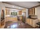 Well-lit open kitchen featuring custom cabinets, a farmhouse sink, and stainless steel appliances with hardwood floors at 34498 Forest Estates Rd, Evergreen, CO 80439