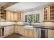 Bright kitchen featuring custom cabinets, stainless steel appliances, and a farmhouse sink under a mountain view window at 34498 Forest Estates Rd, Evergreen, CO 80439