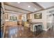 Spacious kitchen with custom cabinets, stainless steel appliances, hardwood floors, and a breakfast bar at 34498 Forest Estates Rd, Evergreen, CO 80439