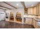 Gourmet kitchen features custom cabinets and shelving alongside a double oven and cooktop, perfect for the home chef at 34498 Forest Estates Rd, Evergreen, CO 80439