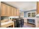 Bright laundry room featuring updated appliances, cabinetry, a sink, countertop space, and a window for natural light at 34498 Forest Estates Rd, Evergreen, CO 80439