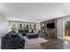 Spacious living room featuring a stone fireplace, large windows, and hardwood floors at 34498 Forest Estates Rd, Evergreen, CO 80439