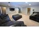 Spacious living room featuring neutral paint, a large sectional, and a large ottoman for optimal comfort at 34498 Forest Estates Rd, Evergreen, CO 80439