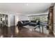 Comfortable living room with stone fireplace, and large windows overlooking wooded area at 34498 Forest Estates Rd, Evergreen, CO 80439