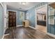 Mud room features wood accents, a sink, blue painted walls, and ample lighting near an exterior door at 34498 Forest Estates Rd, Evergreen, CO 80439