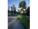 Paved road surrounded by lush green trees and vegetation at 34498 Forest Estates Rd, Evergreen, CO 80439