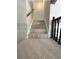 Carpeted staircase with a dark handrail and white trim at 34498 Forest Estates Rd, Evergreen, CO 80439