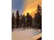 Picturesque winter scene with snow-covered trees and a dramatic sky at 34498 Forest Estates Rd, Evergreen, CO 80439