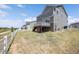 A large backyard with a white fence and a deck attached to the home at 985 Penstemon Dr, Henderson, CO 80640