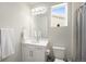 Clean, modern bathroom with white fixtures, vanity, and a window at 985 Penstemon Dr, Henderson, CO 80640