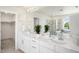 Well-lit bathroom with double sink vanity, large mirror, and a separate shower and tub at 985 Penstemon Dr, Henderson, CO 80640