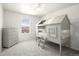 Playful bedroom with custom-built bunk bed in the shape of a house at 985 Penstemon Dr, Henderson, CO 80640