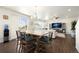 Dining area flowing into the living room with abundant natural light at 985 Penstemon Dr, Henderson, CO 80640