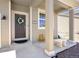 A welcoming front porch with pillars and a decorative wreath on the front door at 985 Penstemon Dr, Henderson, CO 80640