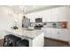 A modern kitchen boasting stainless steel appliances, a large island, and sleek white cabinetry at 985 Penstemon Dr, Henderson, CO 80640