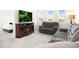 Cozy living room area with an electric fireplace and comfortable seating at 985 Penstemon Dr, Henderson, CO 80640