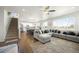 Spacious open floor plan featuring living room and kitchen with stairs at 985 Penstemon Dr, Henderson, CO 80640