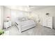 Serene main bedroom with white furnishings, soft carpet, and a view to an ensuite at 985 Penstemon Dr, Henderson, CO 80640