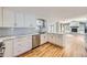 Modern kitchen with white cabinets, marble countertops, and stainless steel appliances at 3630 S Roslyn Way, Denver, CO 80237