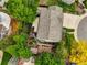 Aerial view showcasing the home's roof, sprawling backyard with stone patio, shed, and mature landscaping at 7513 Simms Ct, Arvada, CO 80005