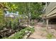 Backyard with wooden bridge and mature trees at 7513 Simms Ct, Arvada, CO 80005