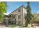 Exterior view of the house, showcasing a well-maintained yard, a deck, and mature landscaping at 7513 Simms Ct, Arvada, CO 80005